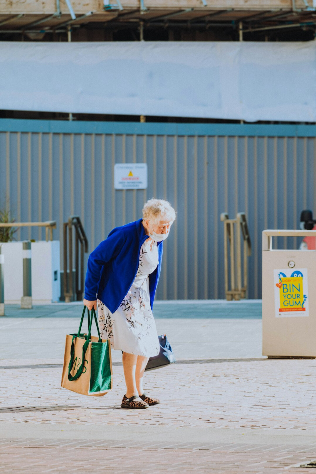 Japanese senior woman happily shopping with a discount card at a local store