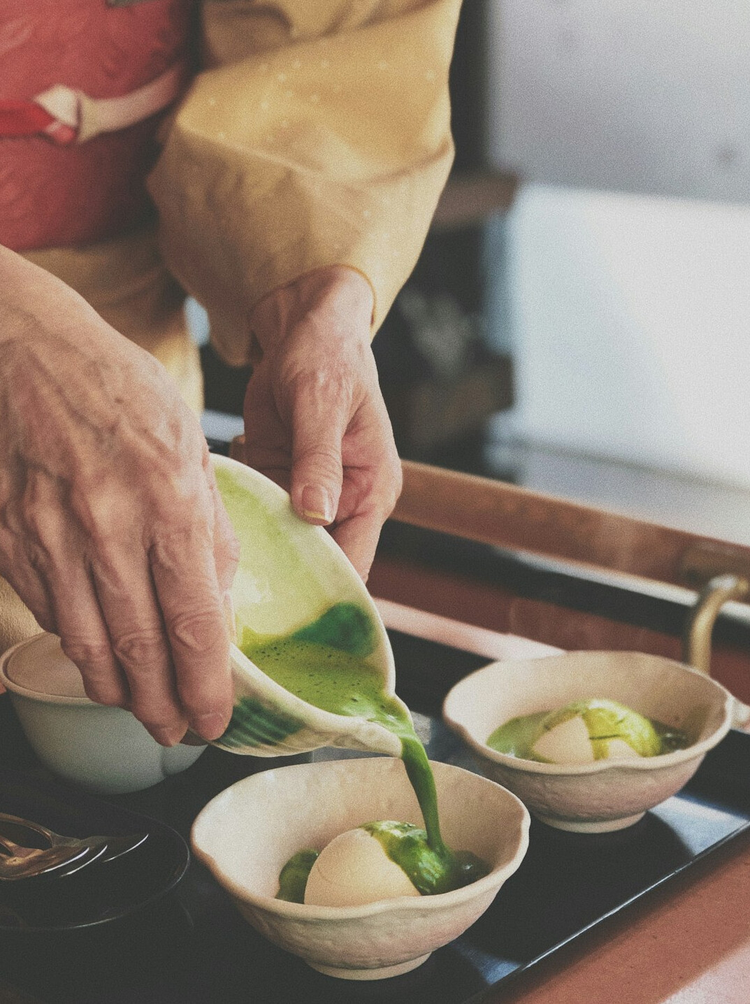 Japanese senior women smiling while preparing matcha tea together