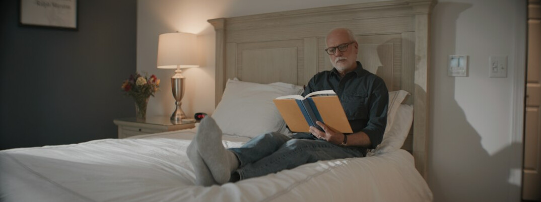 elderly man reading book