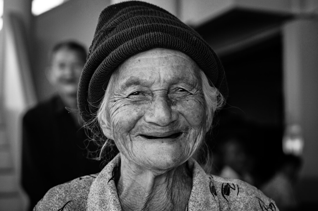 elderly woman smiling in group